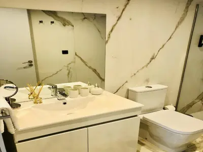 a bathroom with a white sink and a toilet at Convenient apartment in the heart of Porto in Porto