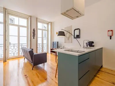 a kitchen with a sink and a desk with a chair at Quaint studio in the heart of Porto in Porto