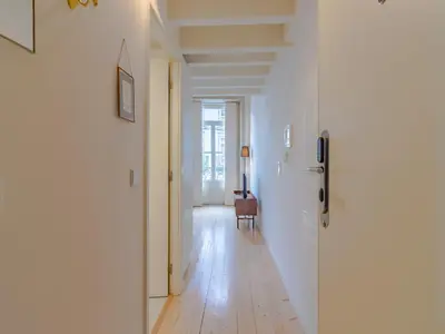a hallway with white walls and a hard wood floor at Charming Porto apartment in prime location in Porto