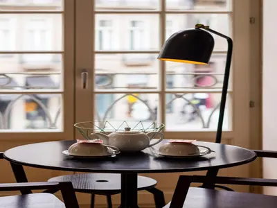 a table with two tea pots and a lamp on it at City-center apartment with modern comforts in Porto