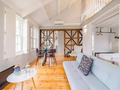 a living room with a couch and a table at City-center apartment with modern comforts in Porto