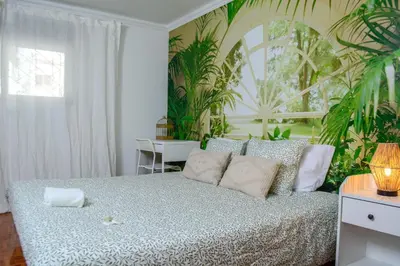 a bedroom with two beds and a blue dog statue at Live Oporto Rooms in Porto
