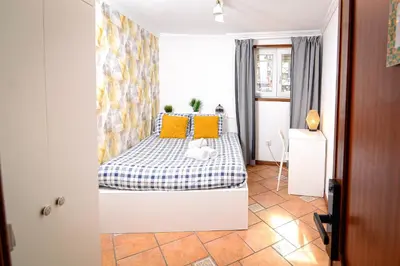 a bedroom with a bed and a desk and a chair at Live Oporto Rooms in Porto