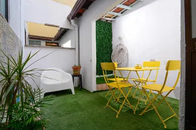 a bedroom with a white bed with two tables at Live Oporto Rooms in Porto