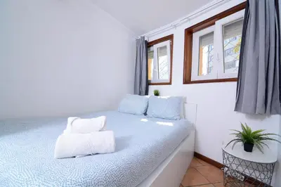 a bedroom with a bed with aigil pillow on it at Live Oporto Rooms in Porto