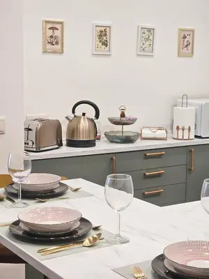 a kitchen with a table with plates and wine glasses at Ninho Santa Catarina in Porto