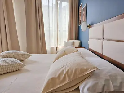 a bedroom with a bed with two pillows on it at Ninho Santa Catarina in Porto