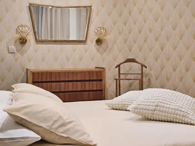 a bedroom with a bed with a mirror on the wall at Ninho Santa Catarina in Porto