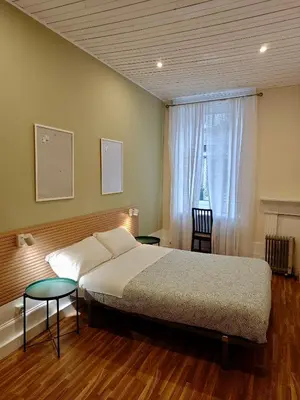a bedroom with a large bed and a window at GuestHouse Bragas Porto Center in Porto