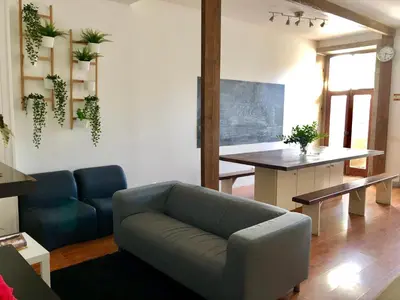 a living room with a couch and a table at GuestHouse Bragas Porto Center in Porto
