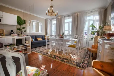 a kitchen and living room with a table and chairs at Cedofeita Village in Porto