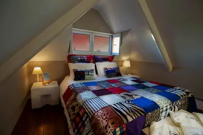 a bedroom with a bed in a attic at Cedofeita Village in Porto