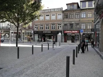a cobblestone street in a city with buildings at Chic Porto Escape Spacious & Central in Porto