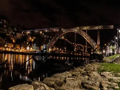 a bridge over a body of water at night at Chic Porto Escape Spacious & Central in Porto