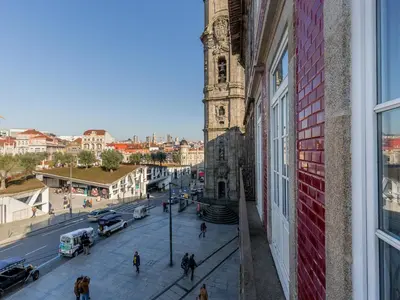 a view of a city street with a clock tower at Charming Apartment with street-view in Porto in Porto