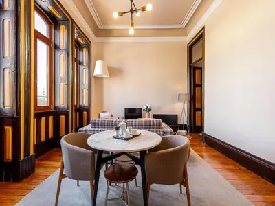 a living room with a table and chairs at Charming Apartment in Porto's Heart in Porto