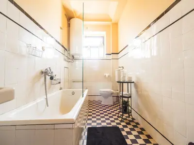 a bathroom with a tub and a toilet and a sink at Pet-friendly apartment in Porto in Porto
