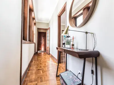 a hallway with a table and a mirror on the wall at Pet-friendly apartment in Porto in Porto