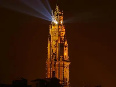 a clock tower at night with a light on it at Pet-friendly apartment in Porto in Porto