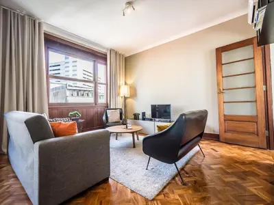 a living room with a couch and a chair at Pet-friendly apartment in Porto in Porto