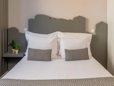 a large white bed with two pillows on it at Porto Pet-Friendly Stay in Porto