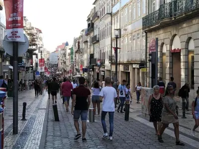 a group of people walking down a street at Porto Pet-Friendly Stay in Porto