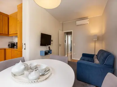a living room with a white table and a blue couch at Porto Pet-Friendly Stay in Porto