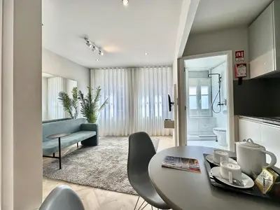 a living room with a table and a couch at Compact & Cozy Retreat in Porto s Heart in Porto