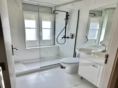a white bathroom with a shower and a toilet at Compact & Cozy Retreat in Porto s Heart in Porto