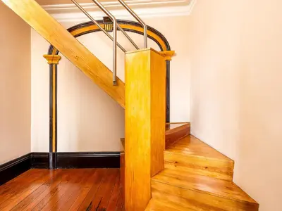 a spiral staircase in a room with wood floors at Duplex 2 Bedroom Apt for 3 in Bolhão Market in Porto