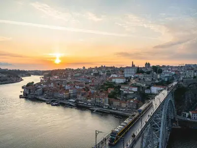 a view of a city with a bridge over the water at Duplex 2 Bedroom Apt for 3 in Bolhão Market in Porto