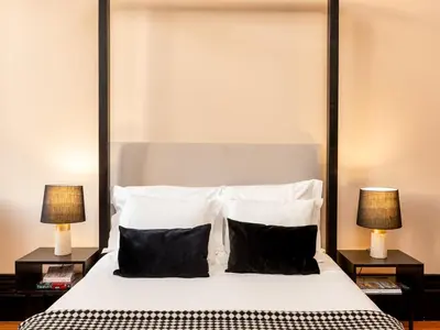 a bedroom with a large white bed with two lamps at Spacious Modern Apartment in Porto in Porto