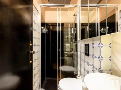 a bathroom with a toilet and a glass shower at Spacious Modern Apartment in Porto in Porto