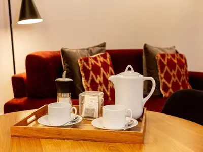 a tray with cups and plates on top of a table at Modern & Cozy apartment, by the beach in Vila Nova de Gaia