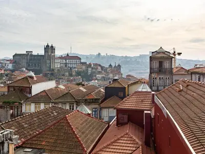 a view of a city with roofs and buildings at Charming 1-Bedroom Apartment in Oporto in Porto