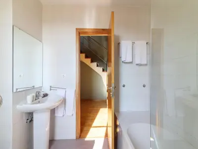 a bathroom with a sink and a staircase at Charming 1-Bedroom Apartment in Oporto in Porto