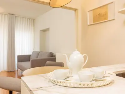 a table with three tea cups and a vase on it at Urban apartment with Balcony in Porto in Porto