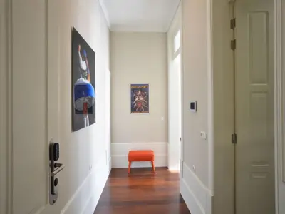 a hallway with an orange chair and a door at Cozy 1-bedroom apartment in Porto in Porto