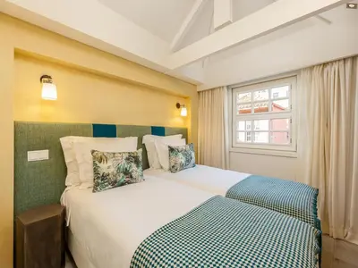 a bedroom with a large white bed with a window at River-View Retreat in Porto in Porto