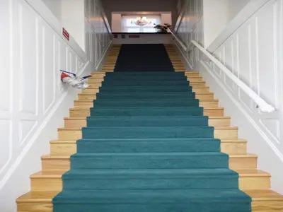 a staircase with blue carpeted stairs in a building at Charming City-Center Studio in Porto in Porto