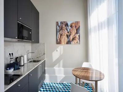 a kitchen with a table and a counter top at Charming City-Center Studio in Porto in Porto