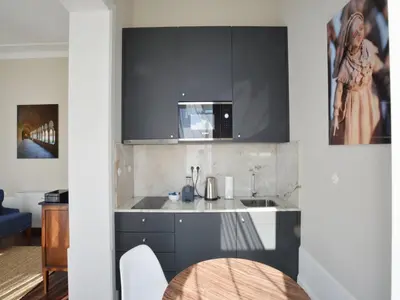 a kitchen with a sink and a table at Charming City-Center Studio in Porto in Porto