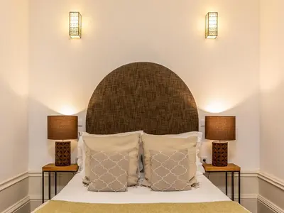 a bedroom with a bed with two lamps at Cozy Porto studio with balcony in Porto