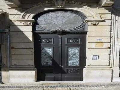 a black door on the side of a building at Modern and cozy apartment in Porto in Porto