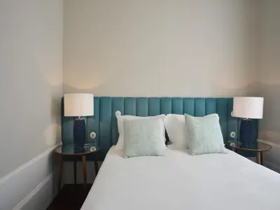 a bedroom with a bed with two lamps on two tables at Modern and cozy apartment in Porto in Porto