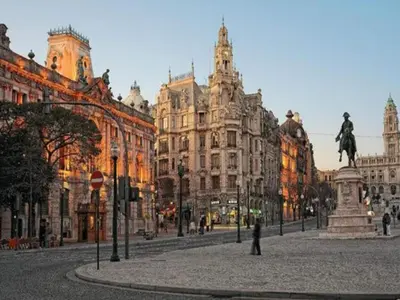 a city street with a statue in front of buildings at Modern and cozy apartment in Porto in Porto