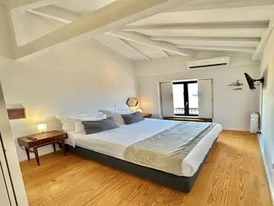 a bedroom with a large bed and a table at Charming 2-Bedroom Apartment in Porto in Porto