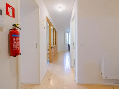 a fire hydrant is hanging on a wall in a hallway at Central Porto Comfort Stay in Porto
