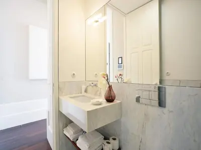 a bathroom with a sink and a mirror at Modern apartment in Porto's Vibrant Heart in Porto