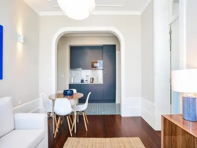a living room with a table and chairs at Modern apartment in Porto's Vibrant Heart in Porto